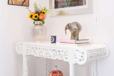Vestibule - small eclectic light wood floor vestibule idea in Miami with white walls