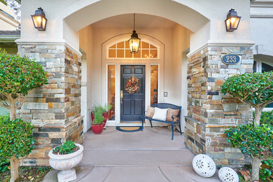 Transitional concrete floor and beige floor entryway photo in Other with white walls and a blue front door