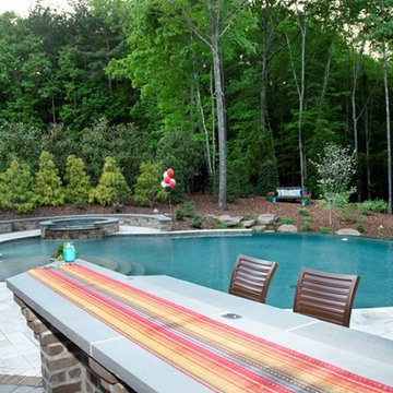 Outdoor bar overlooking fire pit, pool, and hot tub.