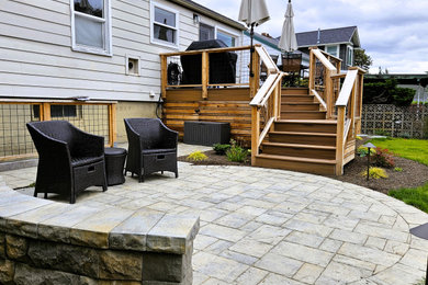 Inspiration for a mid-sized modern backyard wood fence landscaping in Seattle with decking.
