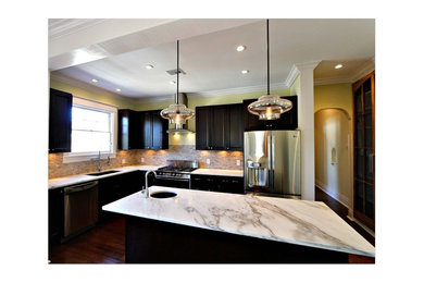 Inspiration for a modern l-shaped dark wood floor and brown floor open concept kitchen remodel in Atlanta with shaker cabinets, dark wood cabinets, marble countertops, ceramic backsplash, stainless steel appliances and an island
