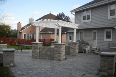 Patio kitchen - backyard patio kitchen idea in Milwaukee with a pergola