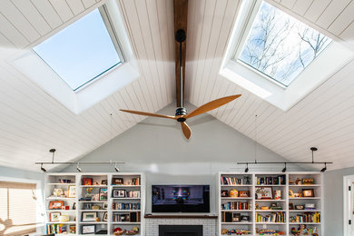 Large cottage chic open concept dark wood floor family room library photo in DC Metro with blue walls, a standard fireplace, a brick fireplace and a wall-mounted tv
