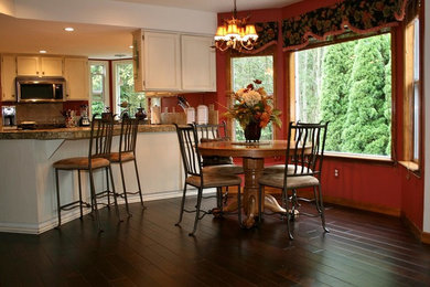 Design ideas for a mid-sized traditional kitchen/dining combo in Portland with multi-coloured walls, dark hardwood floors and brown floor.