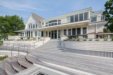Inspiration for a large coastal two-story wood exterior home remodel in New York with a gambrel roof