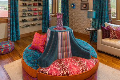 Example of a large eclectic women's medium tone wood floor and brown floor dressing room design in Denver with open cabinets