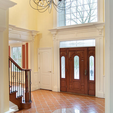 Two-Story Foyer With Paneled Wainscoting and Pilaster Casings