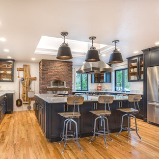 Design ideas for a country kitchen pantry in Portland with with island, shaker cabinets, black cabinets, marble benchtops, stainless steel appliances, medium hardwood floors and grey benchtop.