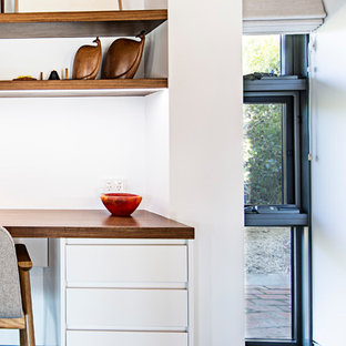 Inspiration for a small modern study in Canberra - Queanbeyan with white walls, slate flooring and a built-in desk.
