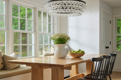 Inspiration for a mid-sized transitional light wood floor and brown floor kitchen/dining room combo remodel in Boston with white walls