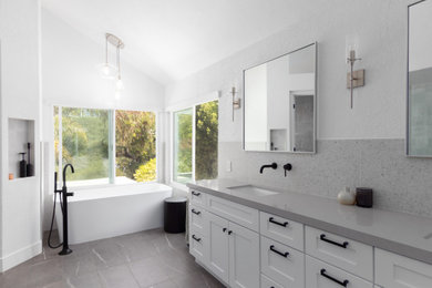 Example of a large minimalist double-sink bathroom design in Orange County with shaker cabinets, white cabinets, quartz countertops, gray countertops and a built-in vanity