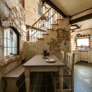 This is an example of a traditional open plan dining in Other with beige walls and black floor.