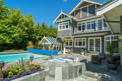 Traditional pool in Vancouver with natural stone pavers.