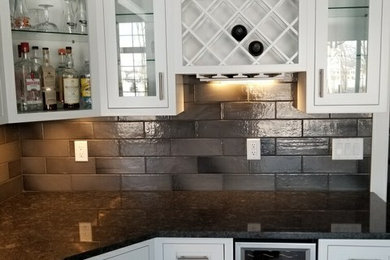 Inspiration for a contemporary kitchen remodel in Other with white cabinets, black backsplash and subway tile backsplash