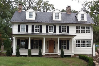Large elegant white two-story vinyl exterior home photo in New York