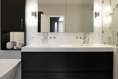 Example of a mid-sized transitional master white tile and stone slab dark wood floor bathroom design in Other with flat-panel cabinets, black cabinets, white walls, an integrated sink and solid surface countertops