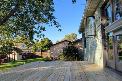 Example of a backyard second story wood railing deck design in Other with no cover