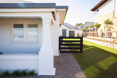 Design ideas for a beach style one-storey brick white house exterior in Adelaide with a flat roof and a metal roof.