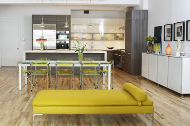 Example of a trendy l-shaped eat-in kitchen design in New York with flat-panel cabinets, stainless steel appliances, gray cabinets and marble countertops