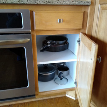 Pull outs shelves for pans next to oven