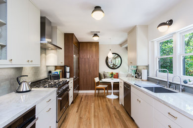 Enclosed kitchen - mid-sized contemporary galley medium tone wood floor and brown floor enclosed kitchen idea in Los Angeles with an undermount sink, flat-panel cabinets, medium tone wood cabinets, quartzite countertops, ceramic backsplash, stainless steel appliances and gray backsplash