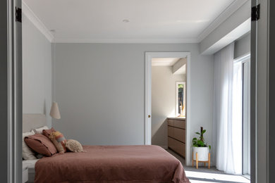 Large scandinavian master bedroom in Melbourne with grey walls, carpet, grey floor and decorative wall panelling.