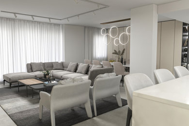 Living room - mid-sized modern open concept porcelain tile, gray floor, exposed beam and wood wall living room idea in Tel Aviv with white walls and no fireplace
