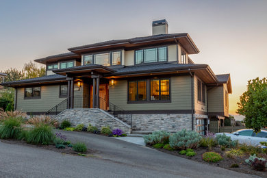 Large contemporary wood house exterior idea in Seattle with a brown roof