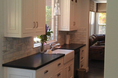 Inspiration for a large transitional dark wood floor kitchen remodel in Indianapolis with a farmhouse sink, stainless steel appliances, shaker cabinets, white cabinets and an island