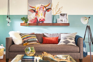 Inspiration for a mid-sized eclectic enclosed laminate floor and brown floor living room remodel in Other with green walls, no fireplace and no tv