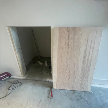 Custom shelving and hidden door