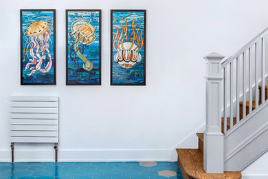 Inspiration for a modern blue floor entryway remodel in DC Metro with white walls and a medium wood front door