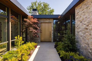 Large contemporary multicolored one-story mixed siding exterior home idea in Vancouver