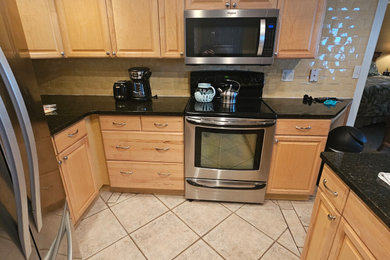 Kitchen - modern ceramic tile kitchen idea in Tampa with an undermount sink, shaker cabinets, white cabinets, quartzite countertops, ceramic backsplash and stainless steel appliances