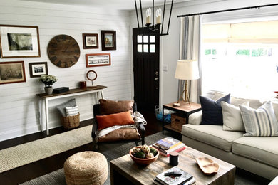 Country formal and enclosed living room photo in New York with white walls and a media wall