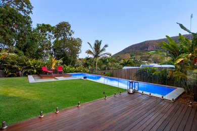Inspiration for a mid-sized tropical front yard l-shaped lap pool in Sunshine Coast with tile.