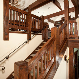 Inspiration for a rustic u-shaped wood railing staircase in Denver with wood risers and slate treads.