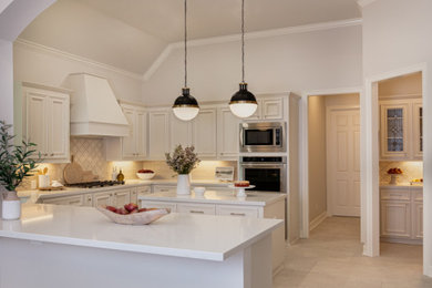 Enclosed kitchen - large traditional u-shaped porcelain tile and black floor enclosed kitchen idea in Houston with an undermount sink, raised-panel cabinets, white cabinets, quartz countertops, beige backsplash, porcelain backsplash, stainless steel appliances, two islands and gray countertops