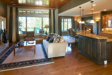 Open concept kitchen - large traditional l-shaped brown floor open concept kitchen idea in Other with raised-panel cabinets, medium tone wood cabinets, granite countertops and an island