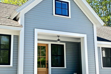 Mid-sized country one-storey grey house exterior in Boston with wood siding, a gable roof and a shingle roof.