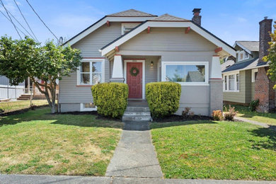 Example of a large arts and crafts gray two-story house exterior design in Seattle