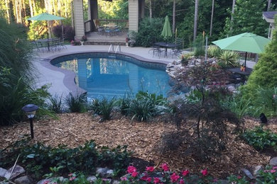Small trendy indoor stamped concrete and custom-shaped pool fountain photo in Atlanta