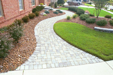 Inspiration for a mid-sized full sun front yard brick garden path in Detroit.