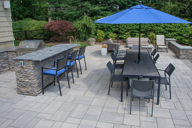 Inspiration for a large timeless backyard brick patio kitchen remodel in New York with no cover