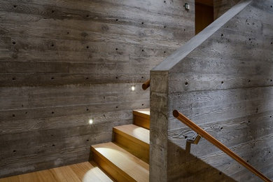 Inspiration for a mid-sized contemporary wooden u-shaped wood railing staircase remodel in Vancouver with wooden risers