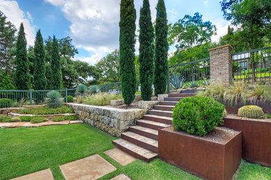 Photo of a large modern full sun front yard stone landscaping in Austin for spring.