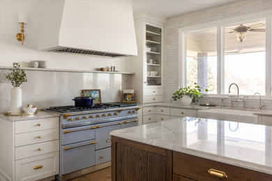 Eat-in kitchen - french country l-shaped eat-in kitchen idea in Omaha with recessed-panel cabinets and an island