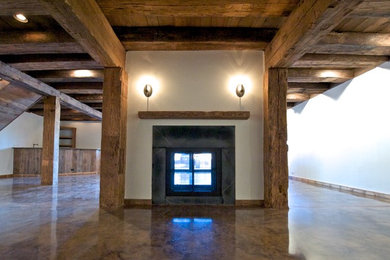 Example of a large trendy open concept dark wood floor, brown floor, wood ceiling and wood wall family room design in Boston with white walls, a standard fireplace, a stone fireplace and no tv