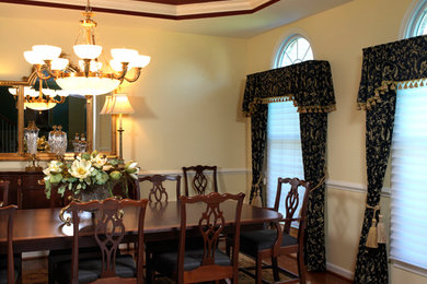 Design ideas for a mid-sized traditional separate dining room in Philadelphia with yellow walls, dark hardwood floors and brown floor.