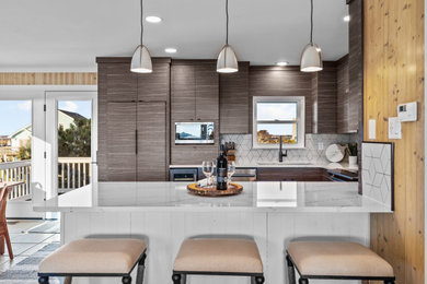 Example of a mid-sized 1950s u-shaped porcelain tile and beige floor eat-in kitchen design in Wilmington with an undermount sink, flat-panel cabinets, gray cabinets, quartz countertops, porcelain backsplash, stainless steel appliances, a peninsula and white countertops